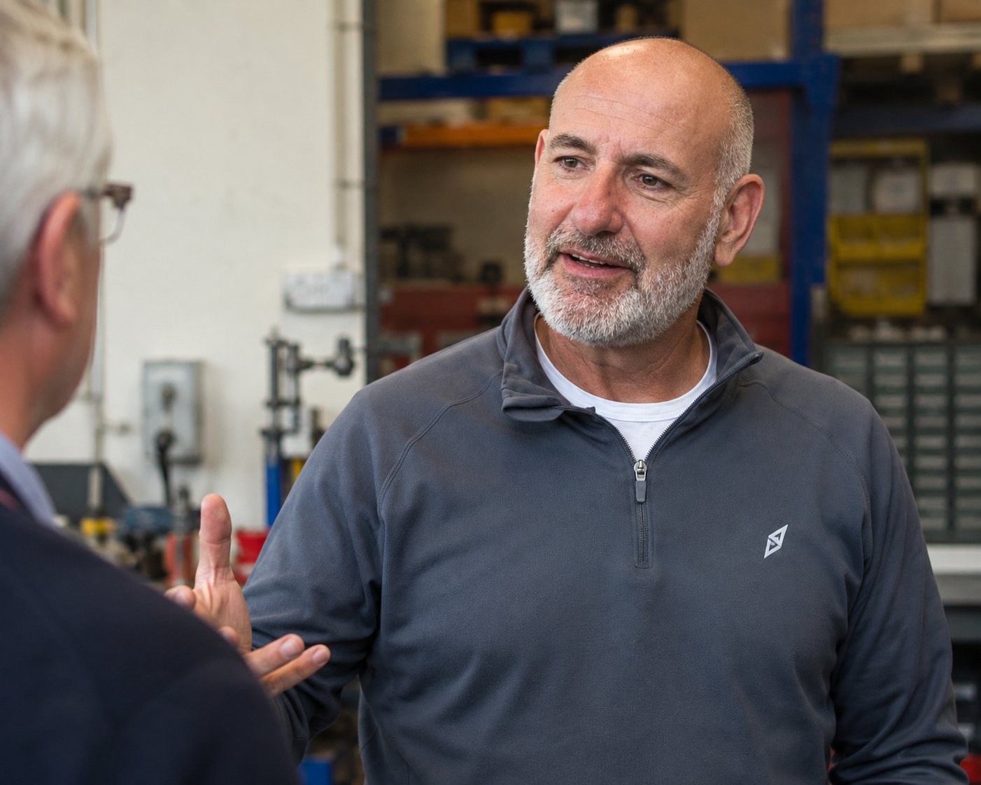 David Landsberg in conversation with a business owner in a workshop.